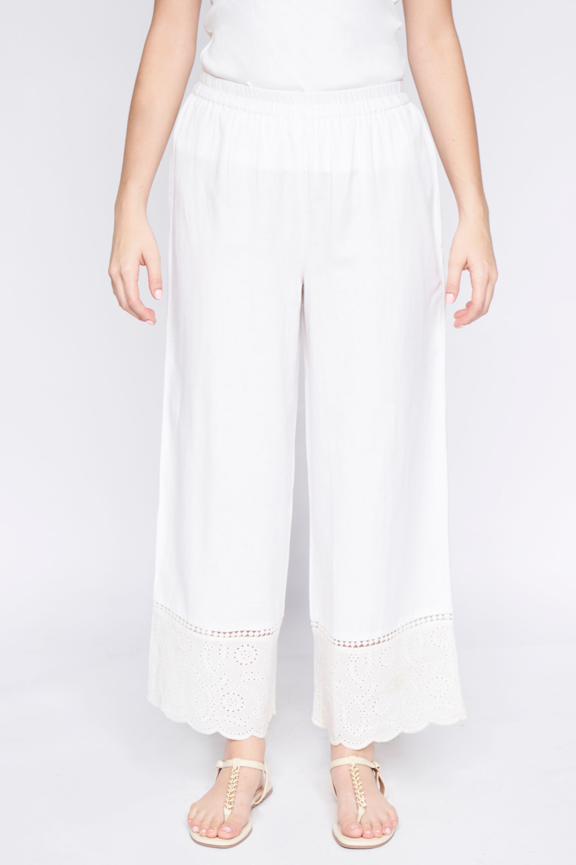 Off white straight pants detailed with lace and embroidery at bottom   Kora India